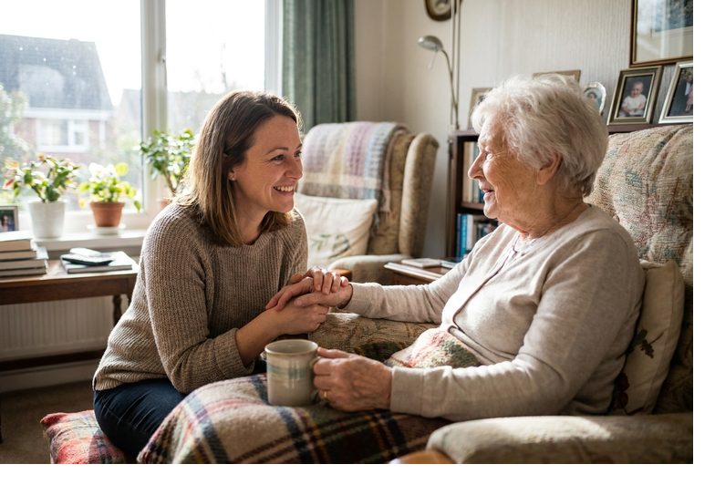 A caregiver sharing tea with an older woman
