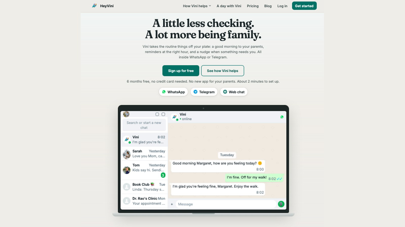 The new hey-vini.com homepage with the WhatsApp demo on a laptop